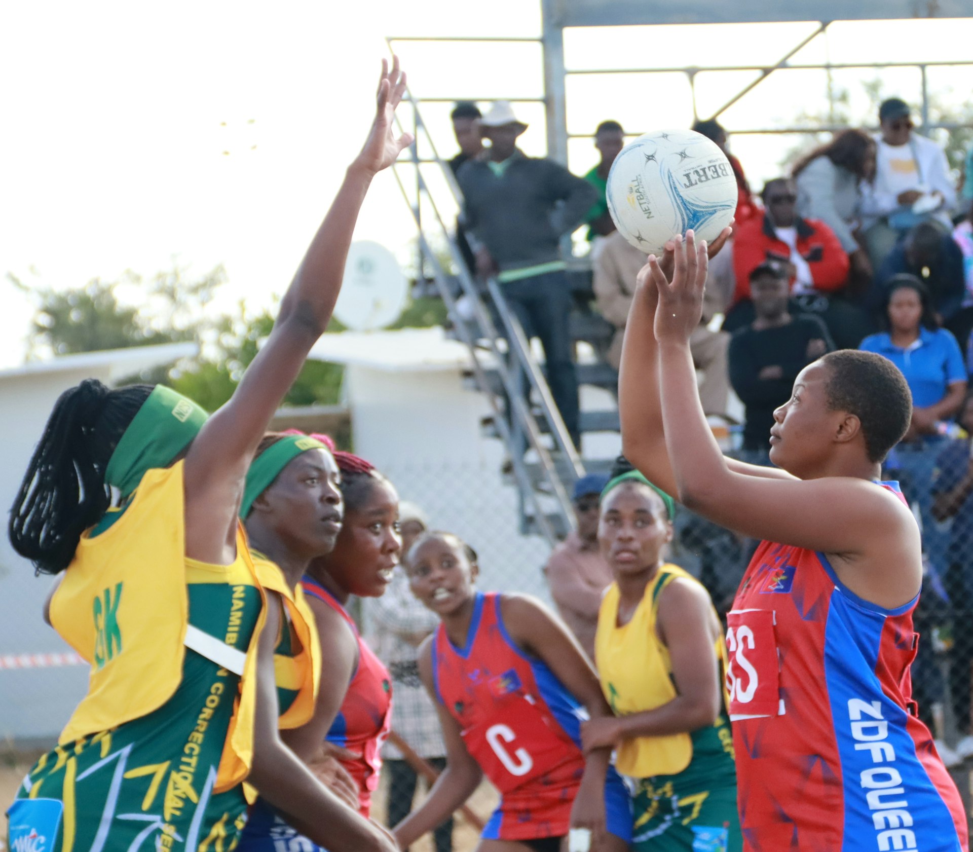 Players are competing in a netball game.